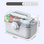 Grey medicine box with transparent lid showing medications, dimensions displayed.