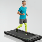 Man using a treadmill with smartphone apps displayed on screen