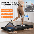 Person using a treadmill with shock-absorbing features highlighted on an advertisement.