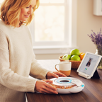 Woman using a signature automatic pill organizer with a tablet on a table.